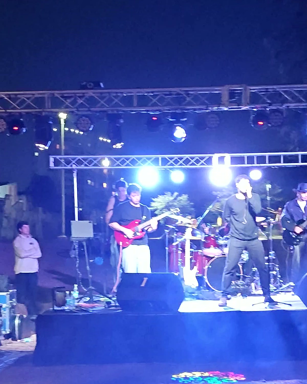 Banda en vivo sobre escenario con monitoreo e iluminación